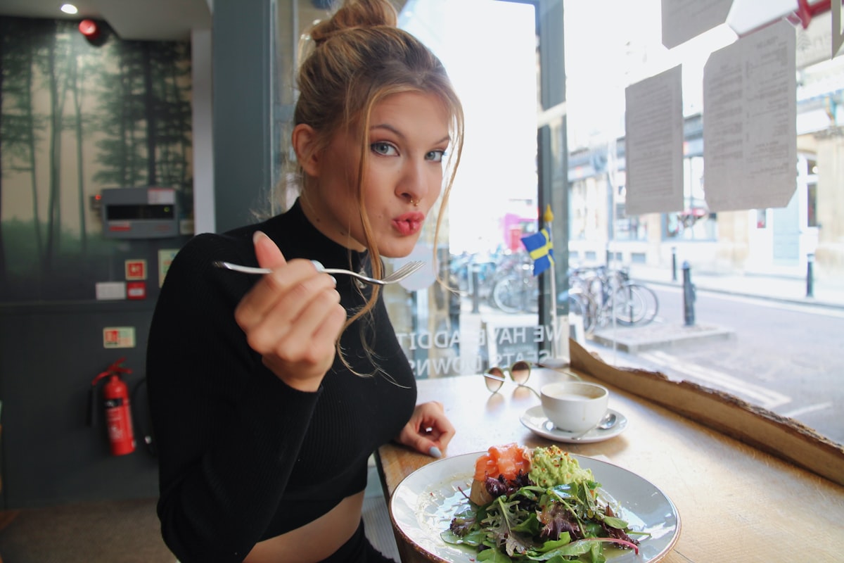 Woman enjoying a healthy, colorful meal with vegetables and whole grains