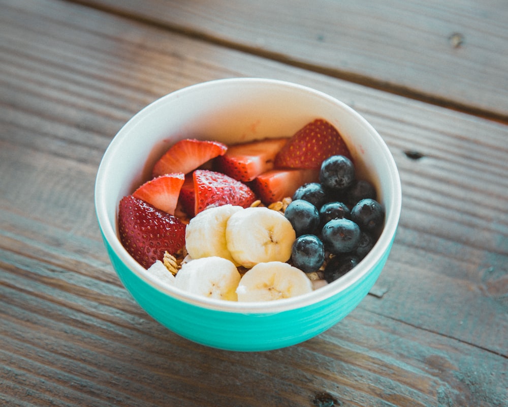 Homemade smoothie in a blender with fresh fruits, yogurt, and leafy greens